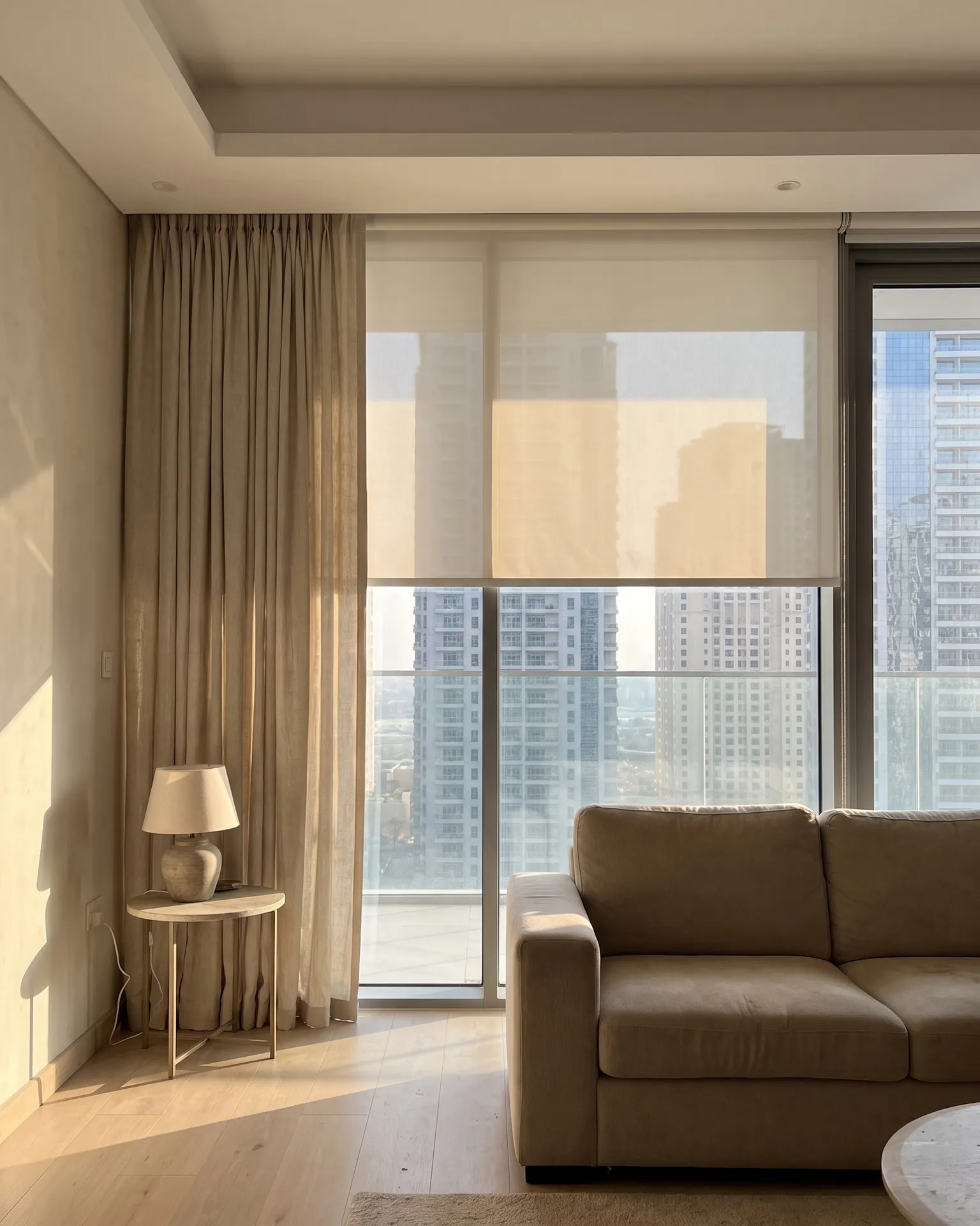 Curtains and blinds on a floor-to-ceiling window in a Dubai living room