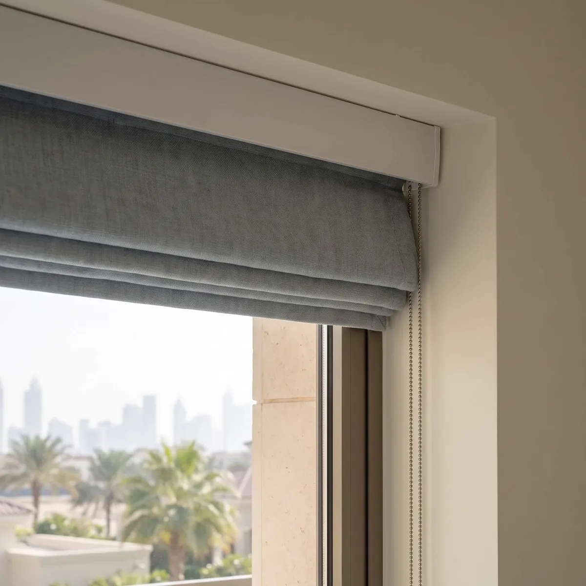 The end of a Roman blind headrail with its control fitted
