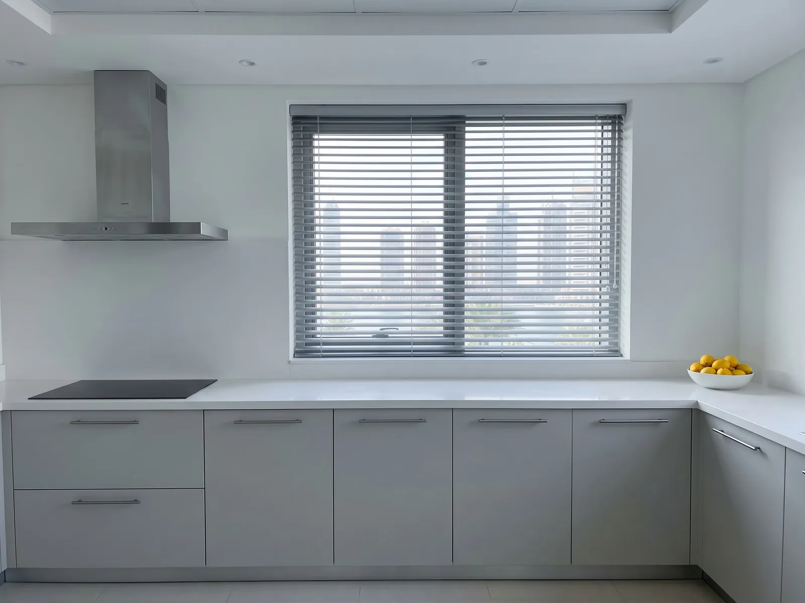 Silver-grey Venetian blind half tilted in a kitchen window, towers and palms in the gaps, a black hob and steel extractor beside it